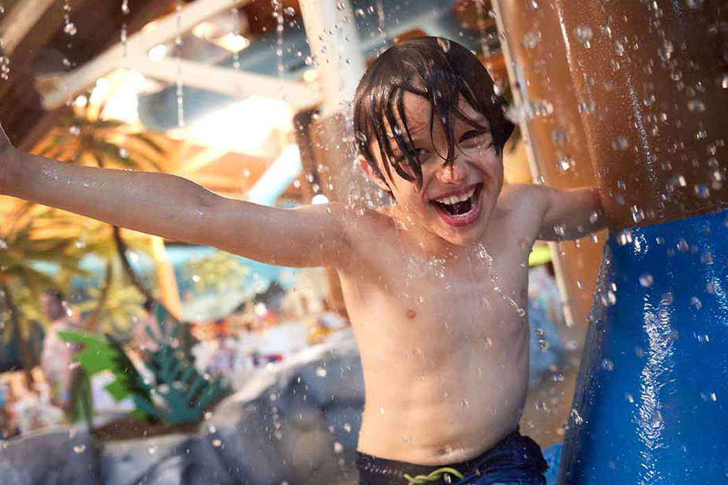 Child enjoying the indoor waterpark at Castaway Bay.